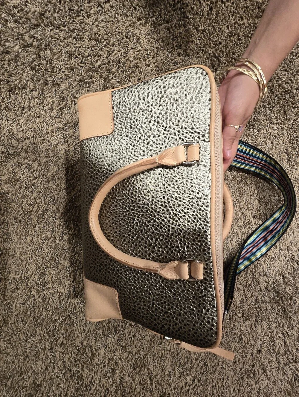 Consuela Tommy Satchel With a textured gold exterior & natural leather handles